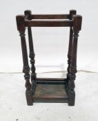 Early 20th century oak umbrella stickstand, the turned and fluted supports to block feet and drip