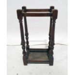 Early 20th century oak umbrella stickstand, the turned and fluted supports to block feet and drip