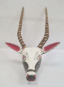 Mexican carved and painted wooden antelope mask with striped horns, red, white and black face