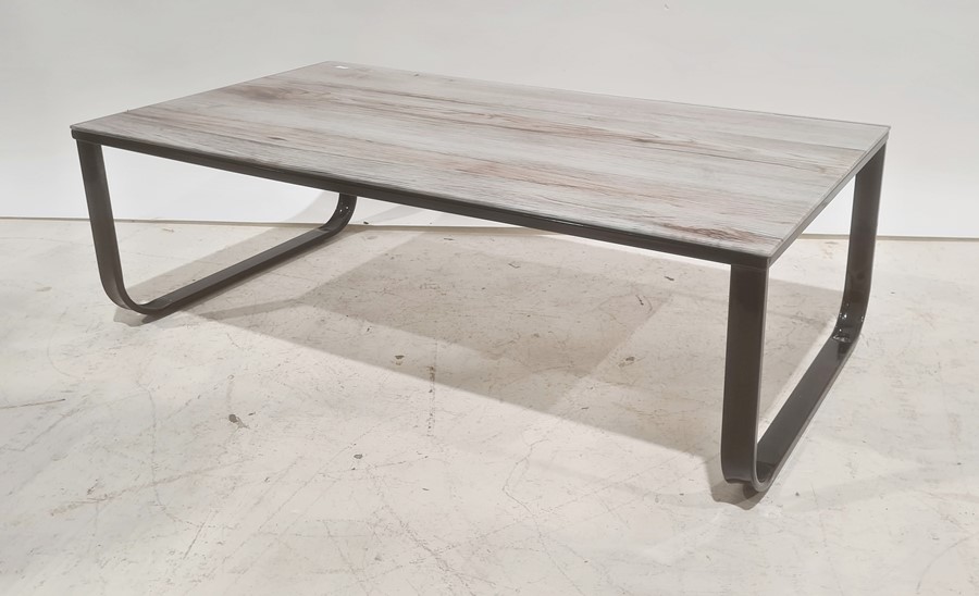Glass-topped rectangular coffee table on black metal base, 104.5cm wide