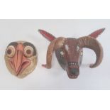 Mexican carved and painted wood bird of prey mask in gilt, orange and black and another rams mask (