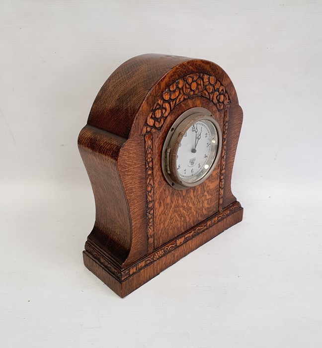 Mid 20th century Smiths oak timepiece, the arched case stylised flowerhead carved on plinth base, - Image 2 of 3