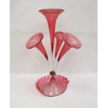 Cranberry and clear glass epergne with central flared trumpet vase, having surround of three