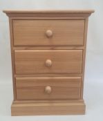 20th century pine bedside chest of three drawers, on plinth base, 49.5cm x 65.5cm