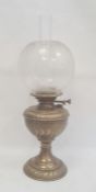 Brass and glass oil lamp with scroll decorated well, on circular foot and the etched bulbous shade