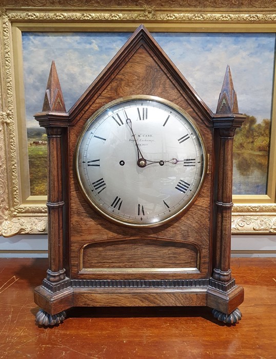19th century rosewood bracket clock having pointed arched top and pointed square section finials,
