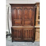 Georgian oak cupboard, the moulded cornice above panelled doors enclosing shelves, the base of two