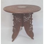 Eastern coffee table with carved and inlaid circular top, folding base