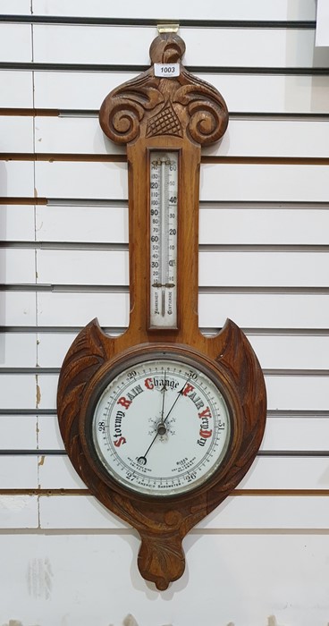 Oak aneroid barometer with scroll pediment, the enamel dial with thermometer, 82cm long overall