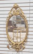 Possibly late 19th century girandole wall mirror, the oval glass plate in moulded frame with two