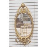 Possibly late 19th century girandole wall mirror, the oval glass plate in moulded frame with two