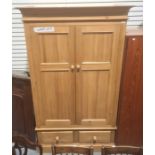 20th century pine wardrobe with moulded cornice above two drawers, on plinth base