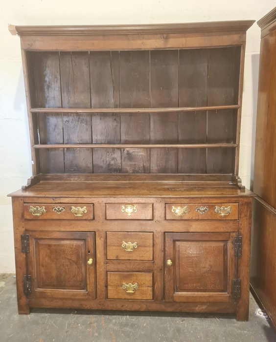 18th century oak dresser, moulded cornice with two shelves, base of five assorted drawers and two
