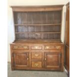 18th century oak dresser, moulded cornice with two shelves, base of five assorted drawers and two
