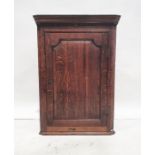 18th century oak wall-hanging corner cupboard with moulded cornice above single panelled door