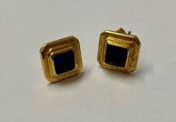 Pair gold-coloured metal and blue stone set earrings, each set square stone in stepped surround