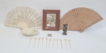 Bone cocktail sticks, Eastern carved stone figure, wooden brise fan, lace and bone fan and a