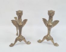 Pair of brass firedogs, each in the form of winged lion to the front support (2)