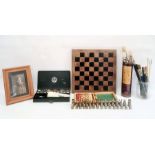 Brass chess pieces, a miniature travelling chess set, quantity of painting items and a photo album