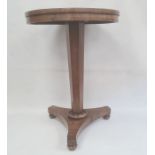 19th century rosewood centre table, the circular top on faceted pedestal, triform base to turned
