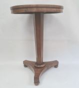 19th century rosewood centre table, the circular top on faceted pedestal, triform base to turned