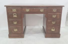 Edwardian walnut pedestal desk, the figured top with moulded edge, the central drawer flanked by