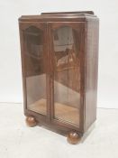 20th century oak display cabinet with two glazed doors enclosing shelves, on bulbous ball feet, 68.