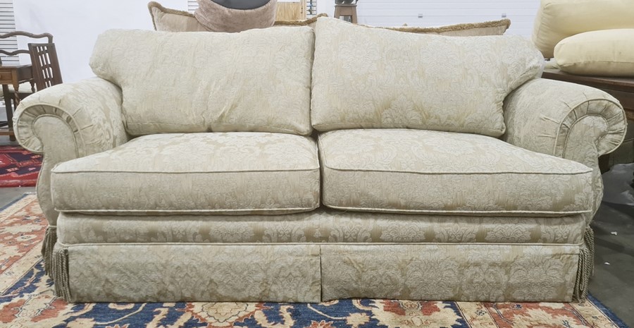 Two-seater sofa and single swivel chair in pale gold upholstery (2)  Condition ReportThe approximate