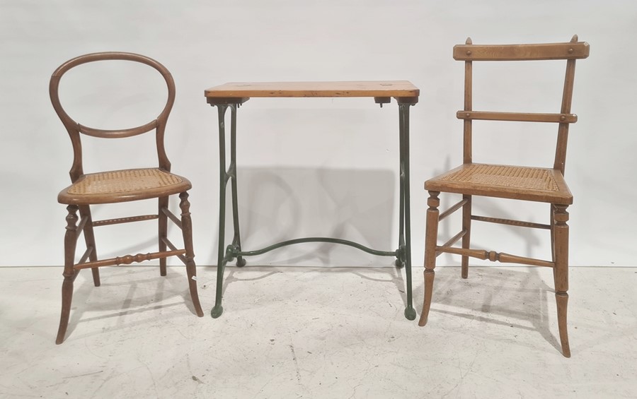 Pine-topped and iron-based table (converted sewing machine) and two cane-seated chairs (3)