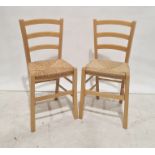 Four 20th century beech framed wicker seated chairs and a linen basket (5)