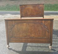 Early to mid-20th century walnut bed, both the headboard and footboard with arched decoration with