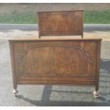 Early to mid-20th century walnut bed, both the headboard and footboard with arched decoration with