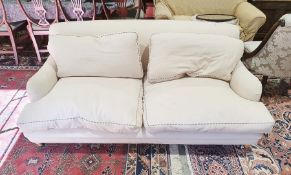 Modern armchair and two seat sofa in the manner of Howard and possibly by George Smith, in cream