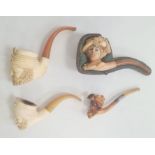 Three meerschaum and amber pipes, two turbanned gentleman, Edwardian lady with feathered bonnet