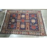 Modern Eastern-style blue ground rug in blues, reds, creams and yellows, 196cm x 135cm