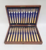 Set of 12 pairs EPNS and yellow-handled fish eaters in mahogany case