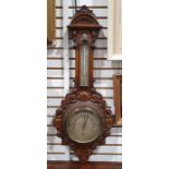 Victorian carved walnut aneroid barometer with carved arched pediment, thermometer above the dial
