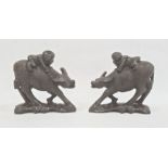 Pair of carved hardwood models of boys riding buffalo, each 12cm high approx. (2)