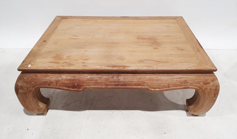 Oriental-style coffee table in limed-effect finish, the rectangular top on four carved supports,