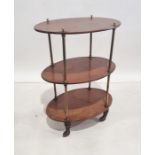 Late 19th/early 20th century three tier trolley, the shelves in oval mahogany united by brass