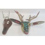 Mexican carved and painted wood stag mask in black, yellow and gold with green spots and another