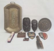 African carved ebony mask comb, an Eastern brass tray, two painted metal shield wall plaques and
