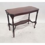 Mahogany two-tier centre table, the shaped top with moulded edge, on turned and reeded supports to