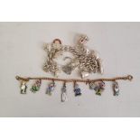 Silver curb link charm bracelet hung with ten assorted charms, some articulated, including a