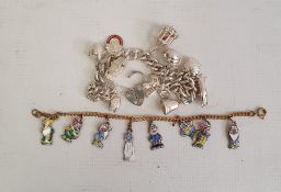 Silver curb link charm bracelet hung with ten assorted charms, some articulated, including a