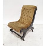 Late Victorian low chair in olive green button upholstery, black ebonised frame, raised on black