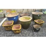 Assorted glazed planters in blues, greens and browns, largest 47cm diameter (8)