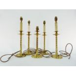 Five brass table lamps with twisted column, on circular foot, four have faux-candle fittings, 29cm