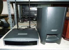 Bose CD player GSX series and a Bose Acoustimass speaker and two box multimedia speakers on stands