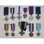 Eleven copies / reproduction metals to include Victoria Cross and Military Cross enclosed in